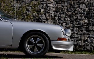 Driver enjoying a scenic road in a classic Porsche with Michelin Classic Tires